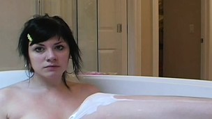 Beautiful brunette Andi receives in the tub and puts on a show shaving her wet crack